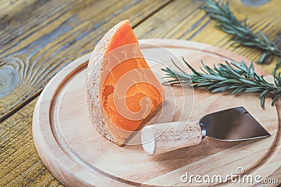 Mimolette cheese on the wooden board Stock Photo