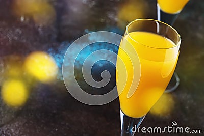 Mimosa alcohol cocktail with orange juice and dry champagne or sparkling wine in glasses, blue background, copy space Stock Photo