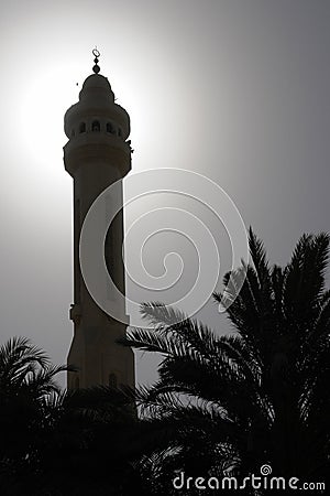 Minaret and date tree silhouette in bahrain Stock Photo