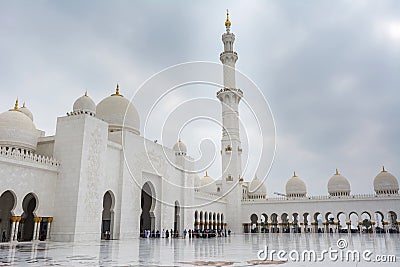 Minaret and domes of white Grand Mosque against white cloudy sky, also called Sheikh Zayed Grand Mosque, inspired by Persian, Editorial Stock Photo