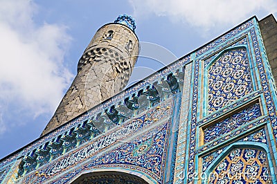 Minaret and the front wall with Arabic mosaics Stock Photo