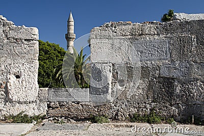 Minaret tower and castle wall in Kos city Stock Photo
