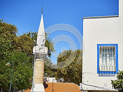 Minaret of Turkkuyusu Cami mosque, view from Turgut Reis street. Editorial Stock Photo