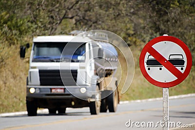 Tank truck and traffic sign indicating forbidden to overtake Editorial Stock Photo