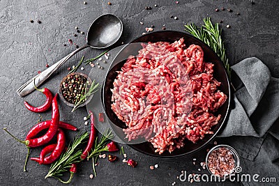 Mince. Ground meat with ingredients for cooking on black background Stock Photo