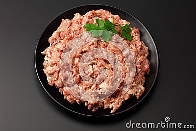 Mince. Ground meat with spices on black background. Top view Stock Photo