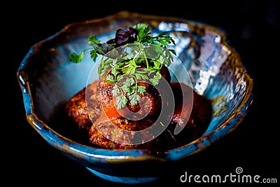 Minced chicken with signature jerk spice marinade drenched in tomato compote Stock Photo