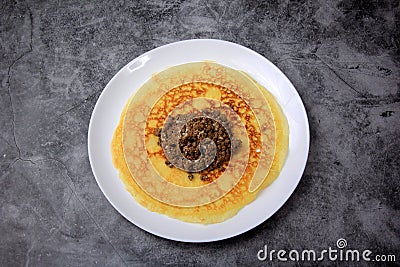 Minced meat filling on a large thin pancake Stock Photo