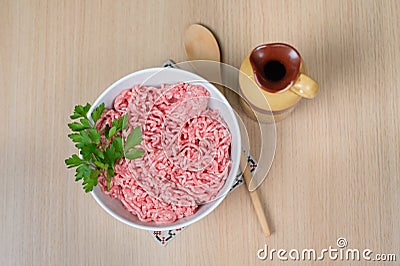 Minced meat in one bowl with parsley Stock Photo
