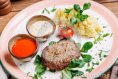 Minced mutton chop with boiled potatoes and sauce Stock Photo