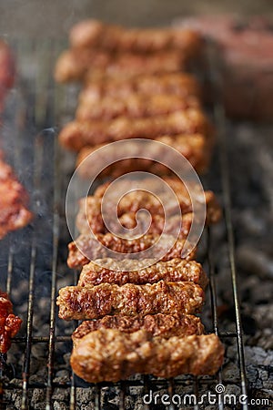 Minced pork rolls on barbecue Stock Photo
