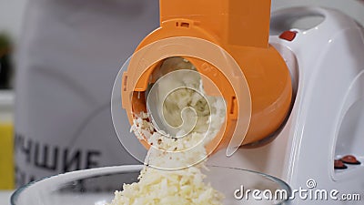 Mincer machine cuts vegetable in kitchen. White electric mincer machines for minced meat per minute, make sausages Stock Photo