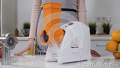 Mincer machine for cutting vegetable in kitchen. White electric mincer machines for minced meat per minute, make Stock Photo