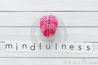 Mindfulness and meditation concept with brain on white wooden background top view Stock Photo