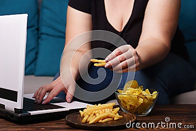 mindless snacking, overeating, lack of physical activity, lazine Stock Photo