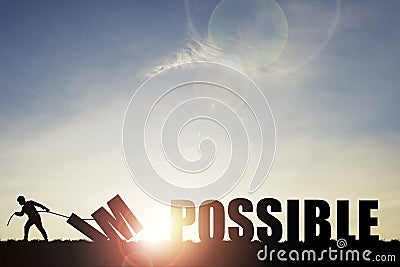 Mindset concept ,Silhouette man pulling impossible to change possible wording on cloud sky and sunlight Stock Photo