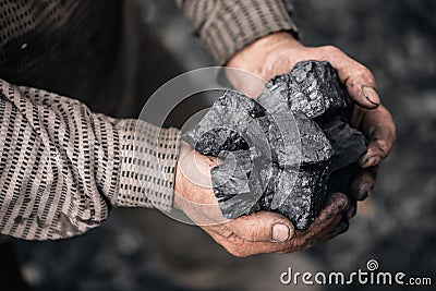 Miner holds coal palm. Concept mining, Top view Stock Photo