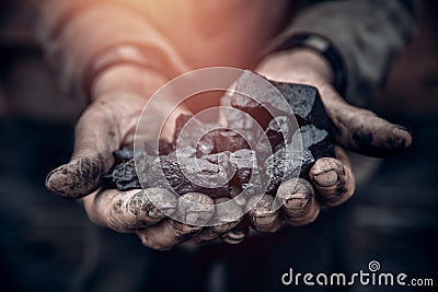 Miner holds coal, palm texture. Concept mining, black stone. Stock Photo