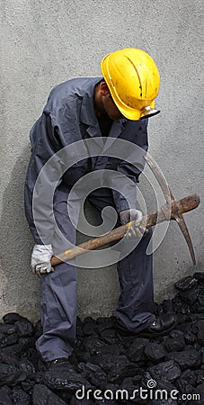 Miner using a pickaxe Stock Photo