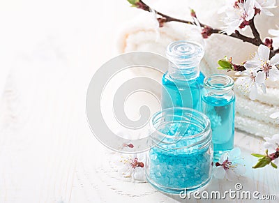 Mineral bath salts, shower gel, towels and flowers . Stock Photo