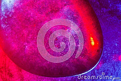 Mineral gem colorfully illuminated in macro capture showing abstract space-type details Stock Photo