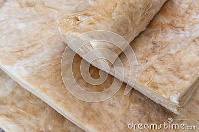 Mineral rockwool lying on attic floor inside house under construction Stock Photo