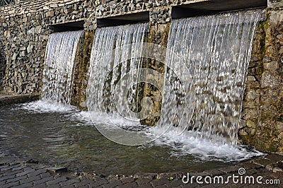 Mineral spring. Stream of floating water like SPA. Curative water in the Resort. Waterfalls in Summer Stock Photo