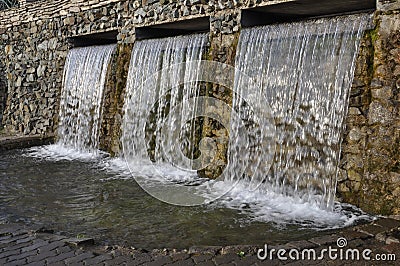 Mineral spring. Stream of floating water like SPA. Curative water in the Resort. Waterfalls in Summer Stock Photo