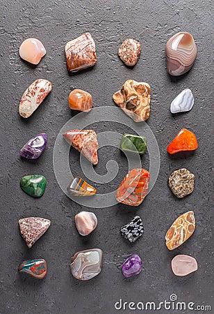 Mineral stones on a black concrete background. The concept of using minerals in astrology and alternative or Stock Photo