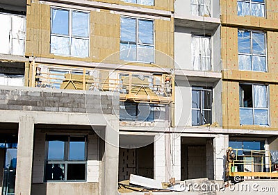 Mineral wool for insulation of the facade building. Insulation for thermal protection to the shell of the house. Suspended cradle Stock Photo