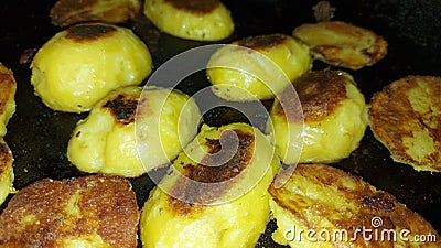 Minerals and vitamins. Roasted potatoes close-up. Halves of potatoes in a pan. Stock Photo