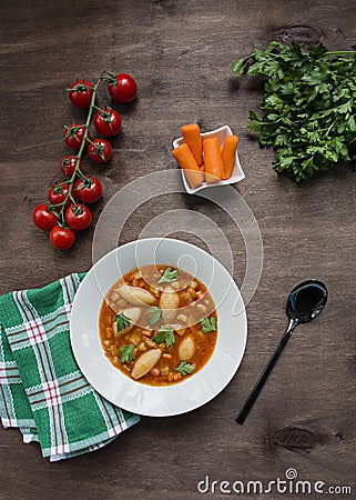 Minestrone soup with pasta and herbs. Italian Cuisine. Dark wooden background. Place for text Stock Photo