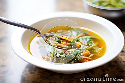 minestrone with spoon, olive oil drizzle on top Stock Photo