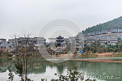 Ming Qing Dynasty Chinese traditional rural house at the lakeside, built with black tiles, stone, and bricks, in Qingyan Ancient Stock Photo