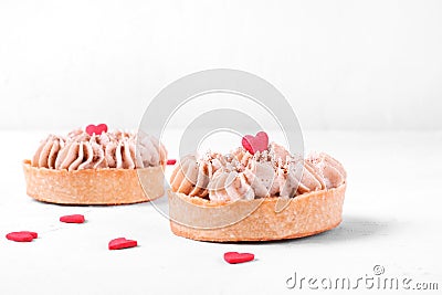 Mini Banoffee pie topped with sugar heart on the white table Stock Photo
