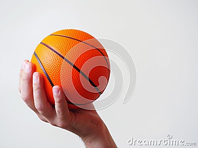 Mini basketball in a hand on a bright background Stock Photo