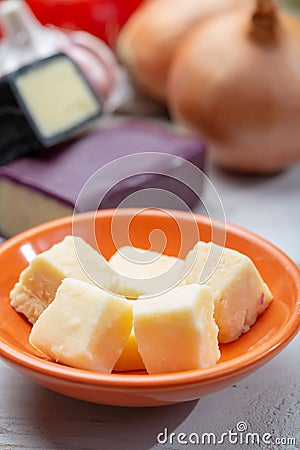 Mini black and dark red waxed cheddar cheeses with strong flavor made from West Country milk and and age-old methods with onion Stock Photo