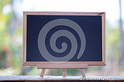 Mini Blank blackboard on wooden table with Copy space . chalkboard Stock Photo