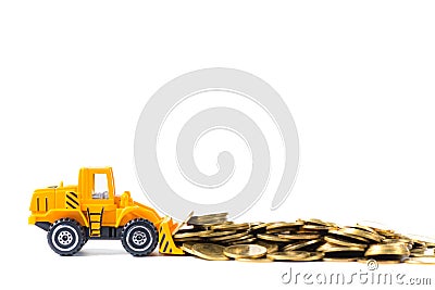 Mini bulldozer truck loading stack coin with pile of gold coin, Stock Photo