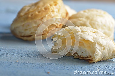 Mini cheese filled baked pies isolated on blue wooden background Stock Photo