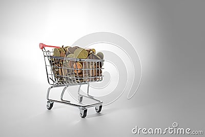 Mini Chrome Shopping Cart Filled To the Top With Coins Stock Photo