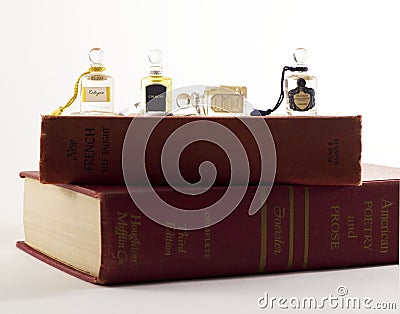 Mini cologne/ perfume bottles on stack of vintage books Stock Photo