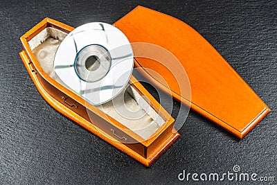 Mini compact disc or pocket compact disc in coffin.Concept Stock Photo
