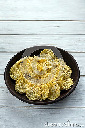 Mini corn bread with salt and olive herbs in a clay plate on a white board. Corn cakes. Healthy cereal snacks. Proper nutrition Stock Photo