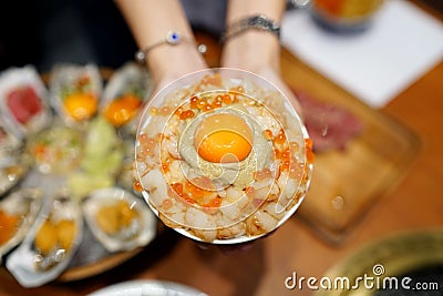 Mini donburi bowl - Japanese rice bowl topped with sweet shrimp, kani miso crab, salmon roe and topping egg yolk, Japanese Stock Photo