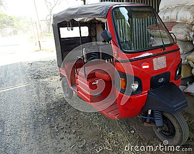 Mini Electric Rickshaw image, Red Rickshaw image, Background, SelectiveFocus, November 13, 2020 in Burdwan,India Editorial Stock Photo