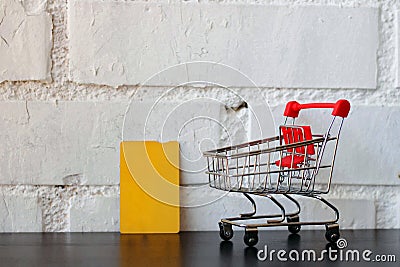 Mini empty shopping cart next to a credit card. Stock Photo