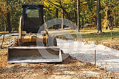Mini excavator at a construction site. Forest road construction Stock Photo