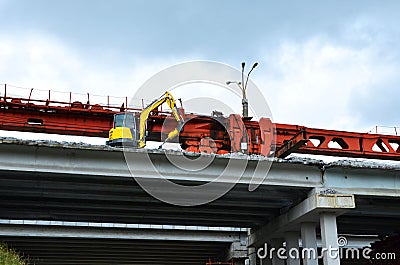 Mini excavator with a hydraulic hammer breaker crushes concrete, reinforcement pile elements and high-strength material. Stock Photo