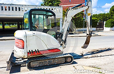 Mini excavator with narrow bucket Editorial Stock Photo